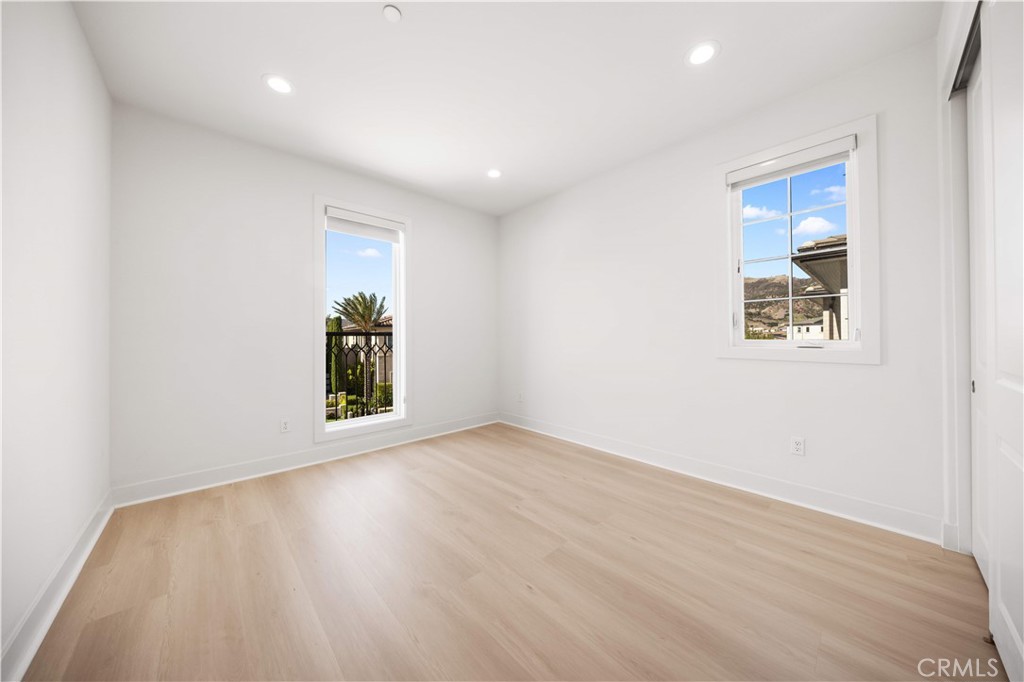 12000 Mirabel Way Porter Ranch, CA 91326 - Photo 41 of 59 an empty room with wooden floor and windows