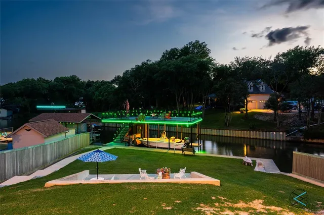 a view of a swimming pool and deck in the backyard of house