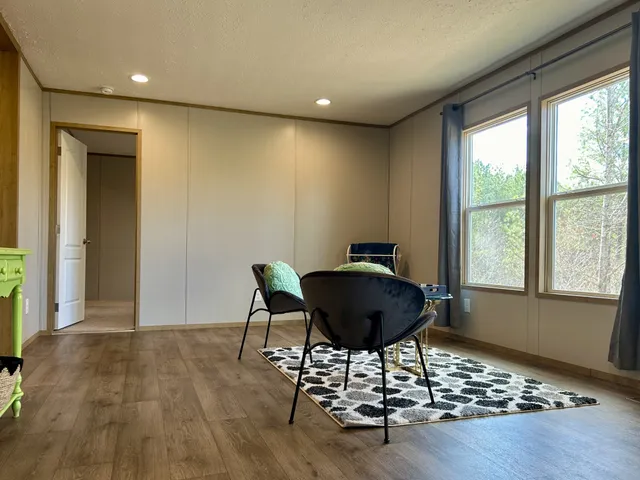 a view of a room with a table and chairs