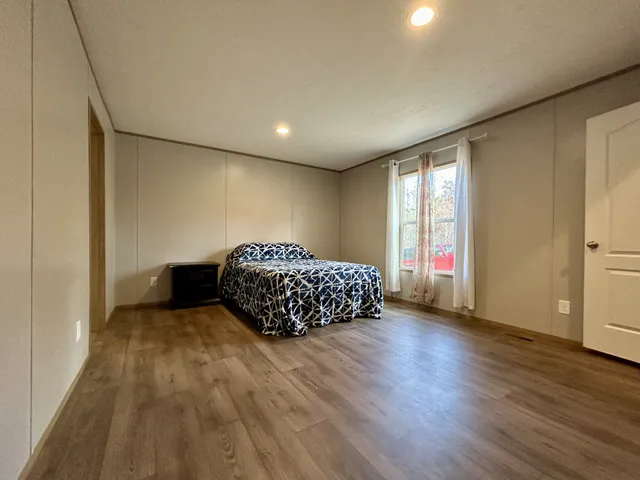 a bedroom with a bed and a window