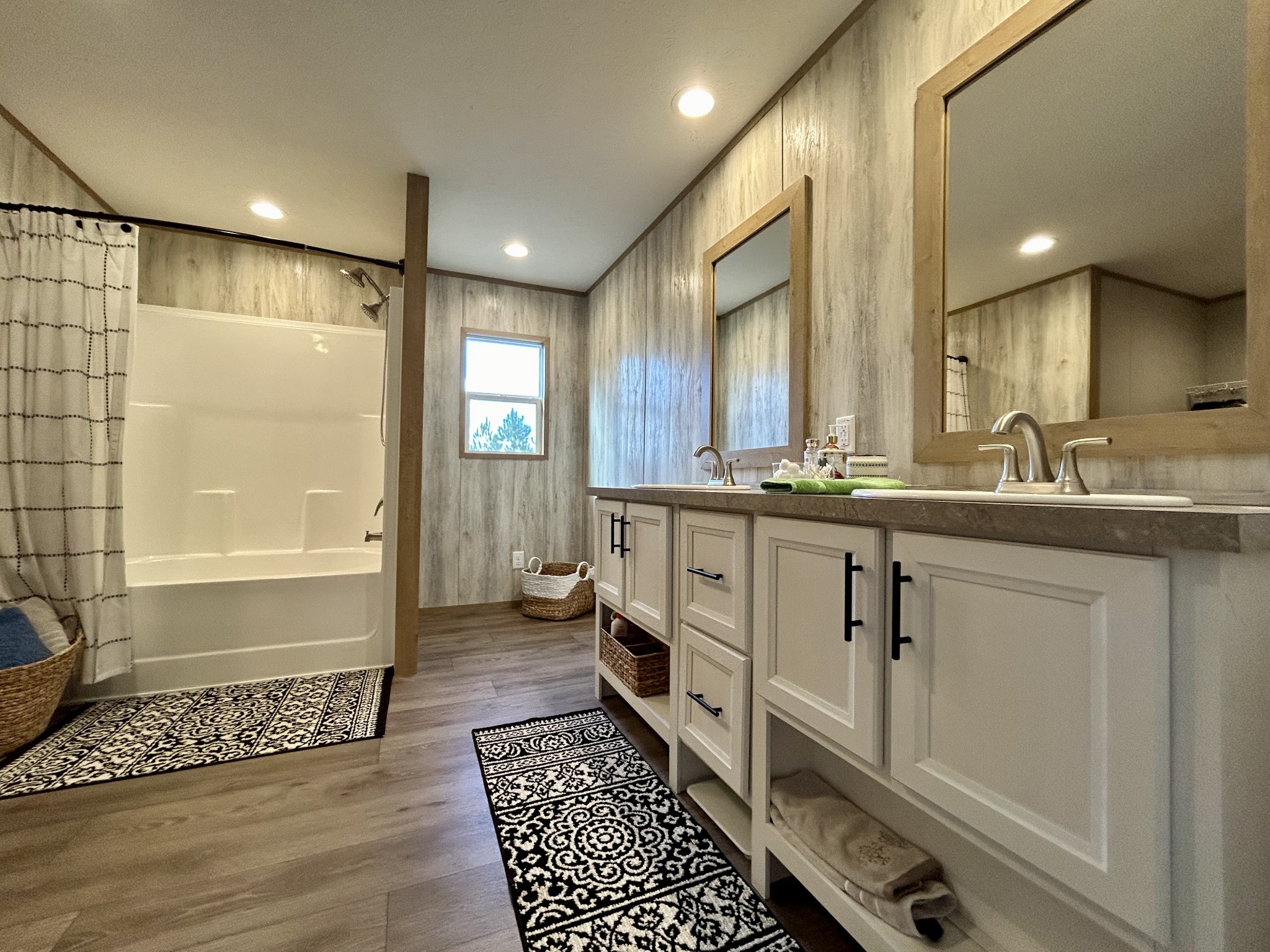 443 Sickler Road Hohenwald, TN 38462 - Photo 20 of 33 a bathroom with a double vanity sink a mirror and a shower