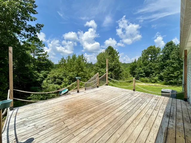 a park view with a wooden floor and fence