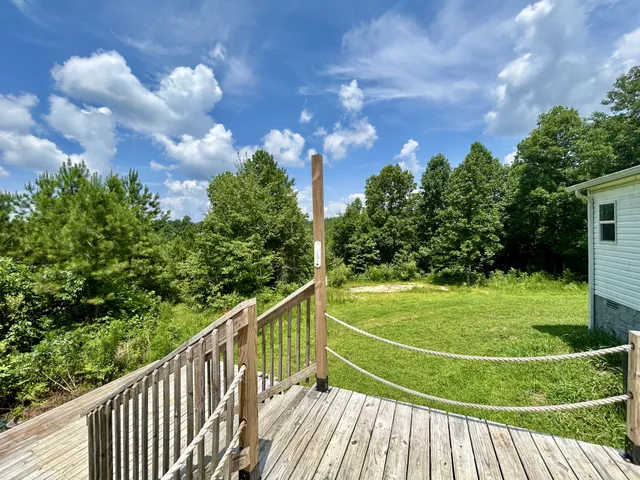 a view of a balcony with yard