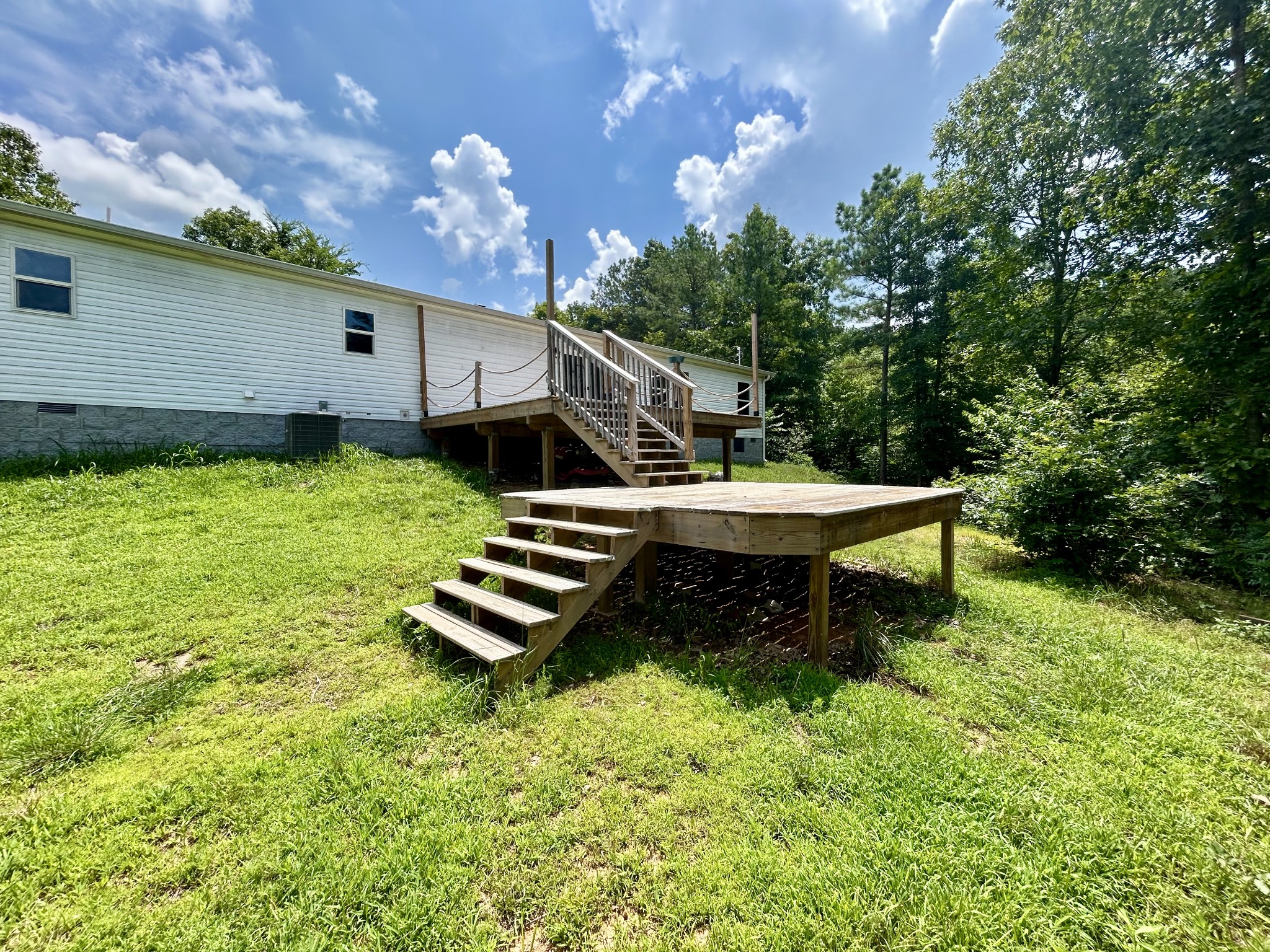 443 Sickler Road Hohenwald, TN 38462 - Photo 26 of 33 a backyard of a house with table and chairs