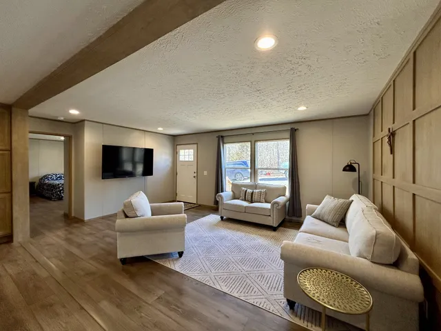 a living room with furniture and a flat screen tv