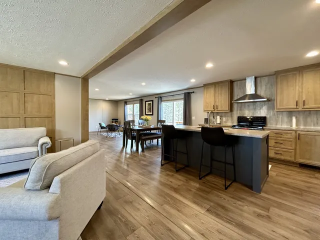 a living room with furniture and kitchen view