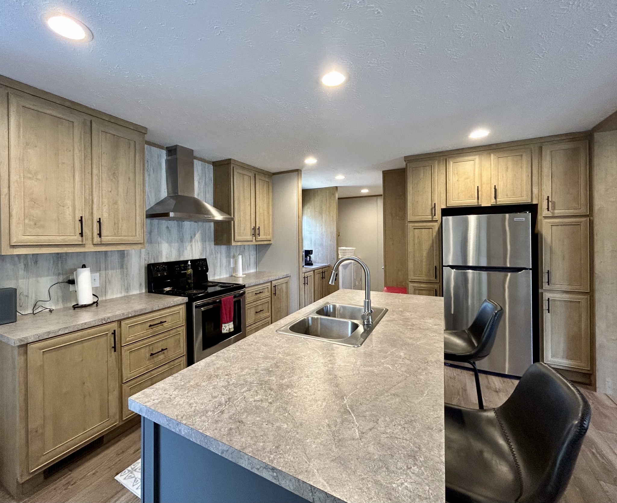 443 Sickler Road Hohenwald, TN 38462 - Photo 6 of 33 a kitchen with stainless steel appliances granite countertop a sink refrigerator and cabinets
