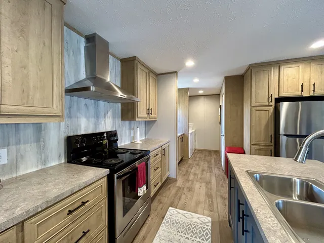 a kitchen with a sink stove and refrigerator