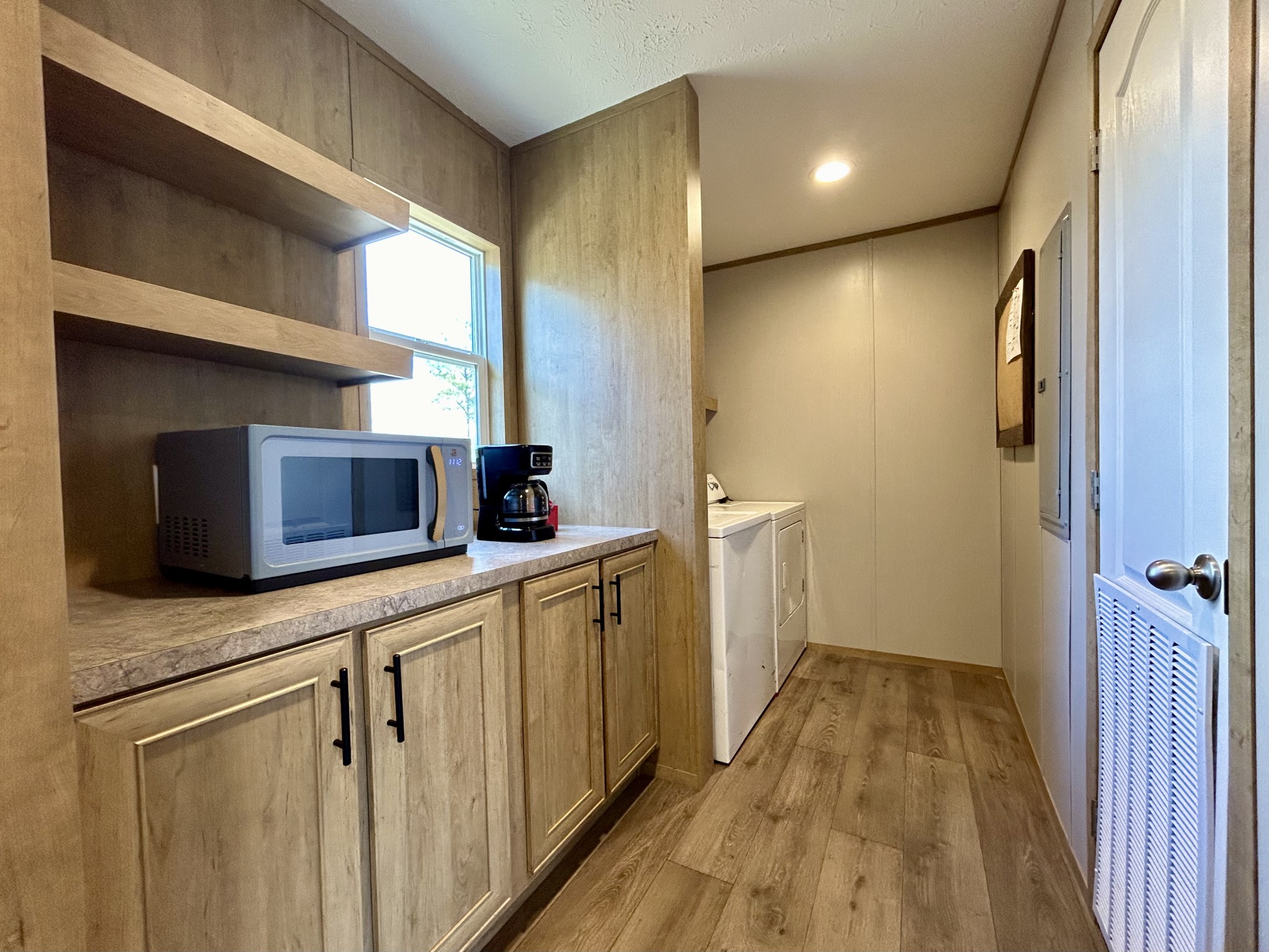 443 Sickler Road Hohenwald, TN 38462 - Photo 10 of 33 a hallway with a sink and wooden floor