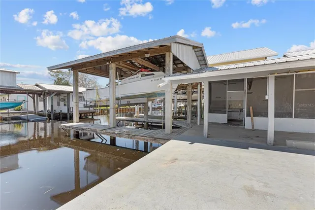 a front view of a house with swimming pool and sitting space