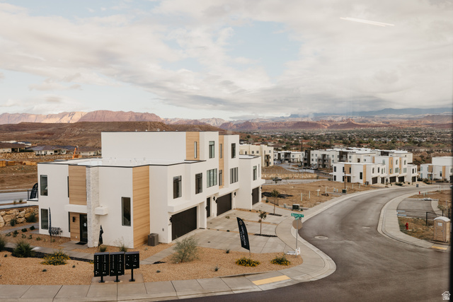 2759 Becco Trail, Unit 16 St. George, UT 84770 - Photo 2 of 42 View of property featuring driveway, an attached garage, a mountain view, and a residential view