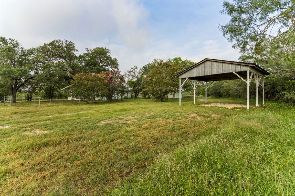 9611 Wilke Road Kingsbury, TX 78638 - Photo 8 of 23 a backyard of a house with table and chairs