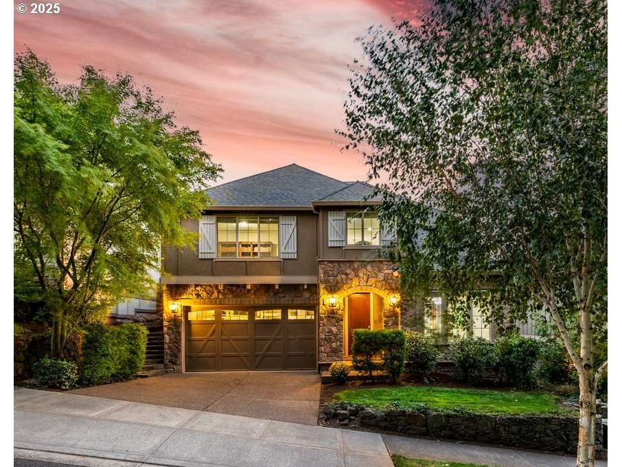 5598 Northwest 135th Avenue Portland, OR 97229 - Photo 1 of 45 a front view of a house with a yard and trees