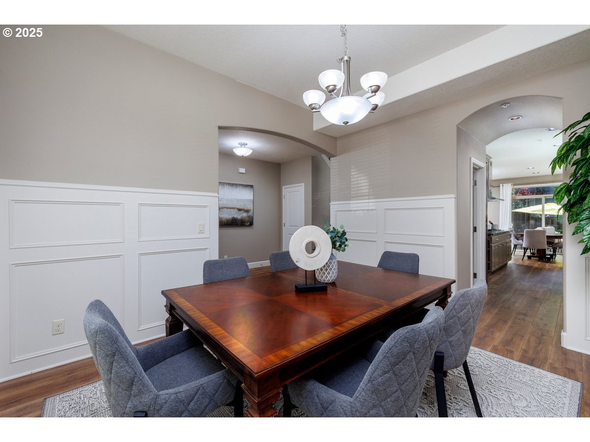 5598 Northwest 135th Avenue Portland, OR 97229 - Photo 11 of 45 a view of a dining room with furniture and wooden floor