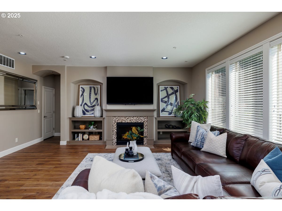 5598 Northwest 135th Avenue Portland, OR 97229 - Photo 19 of 45 a living room with furniture a fireplace and a flat screen tv