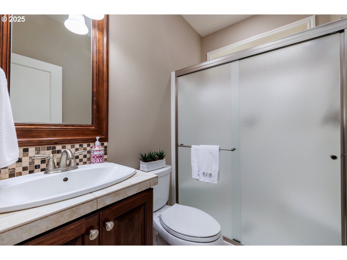 5598 Northwest 135th Avenue Portland, OR 97229 - Photo 25 of 45 a bathroom with a sink toilet and mirror