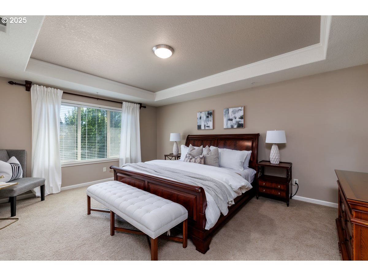 5598 Northwest 135th Avenue Portland, OR 97229 - Photo 27 of 45 a bedroom with a bed a couch and a window