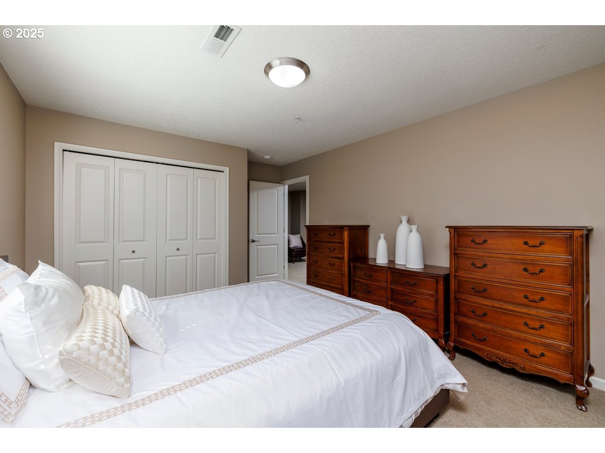 5598 Northwest 135th Avenue Portland, OR 97229 - Photo 35 of 45 a bedroom with a bed and a dresser