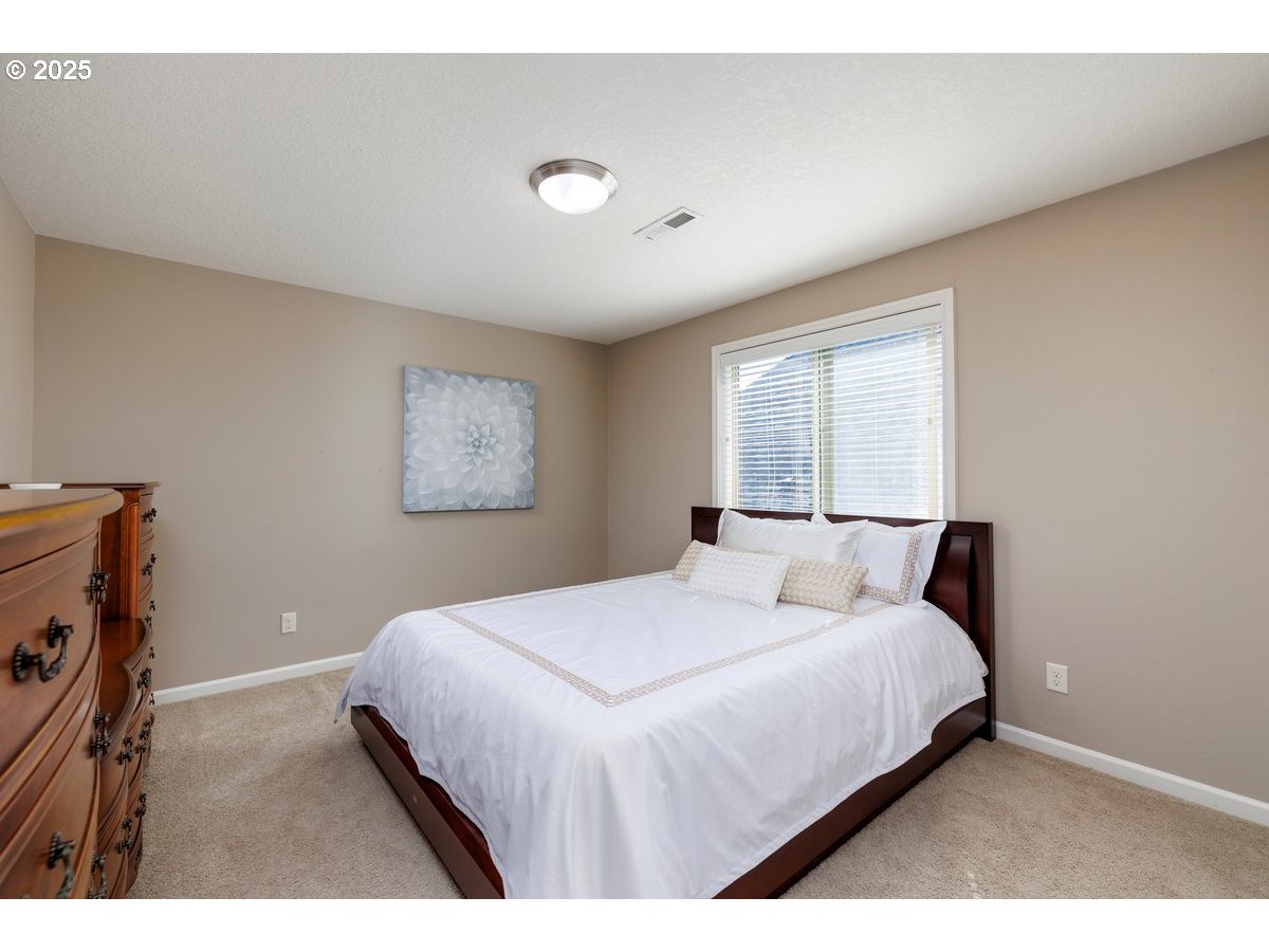 5598 Northwest 135th Avenue Portland, OR 97229 - Photo 36 of 45 a bedroom with a bed and a window