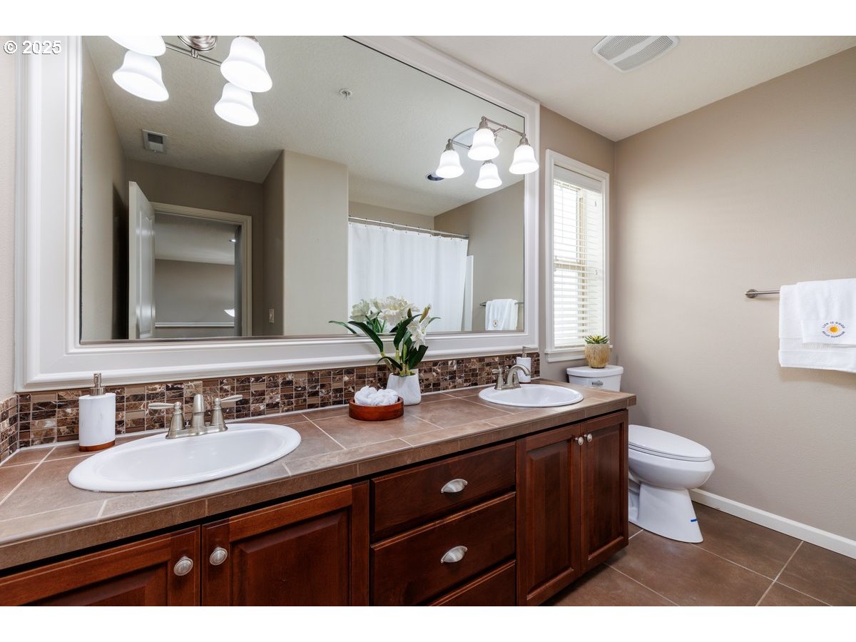 5598 Northwest 135th Avenue Portland, OR 97229 - Photo 38 of 45 a bathroom with a sink double vanity and a mirror