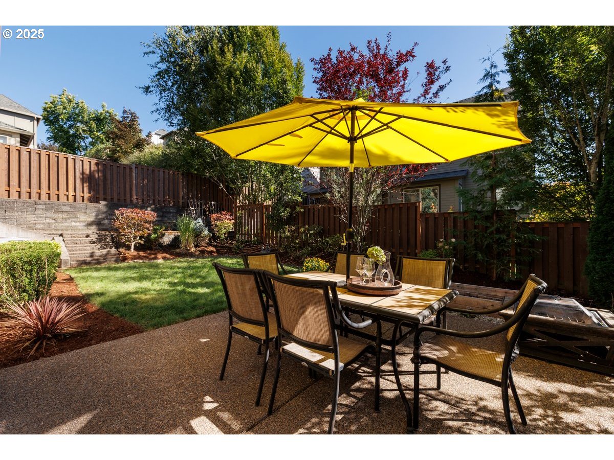 5598 Northwest 135th Avenue Portland, OR 97229 - Photo 42 of 45 a view of patio with chairs and table under an umbrella