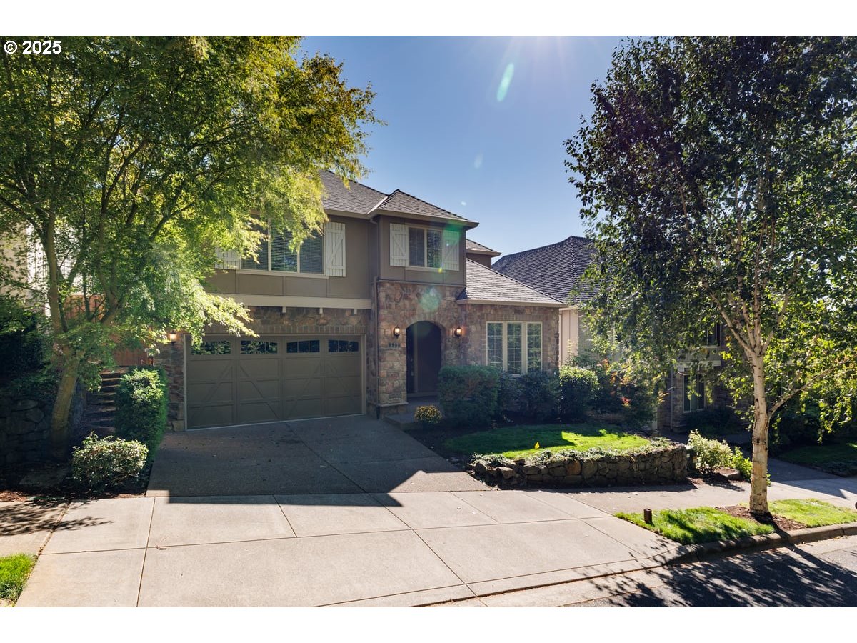 5598 Northwest 135th Avenue Portland, OR 97229 - Photo 5 of 45 a front view of a house with a yard and garage