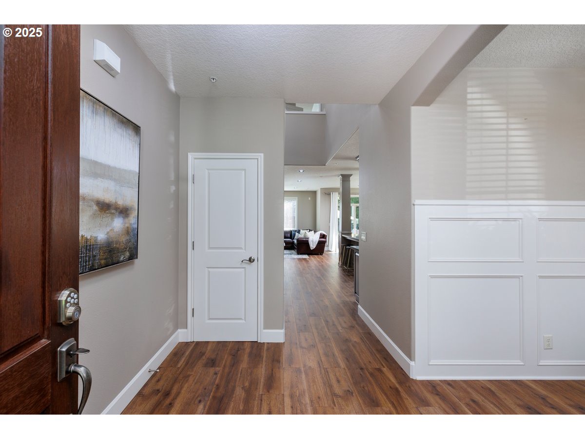 5598 Northwest 135th Avenue Portland, OR 97229 - Photo 9 of 45 a open hall with wooden floor and a bathroom