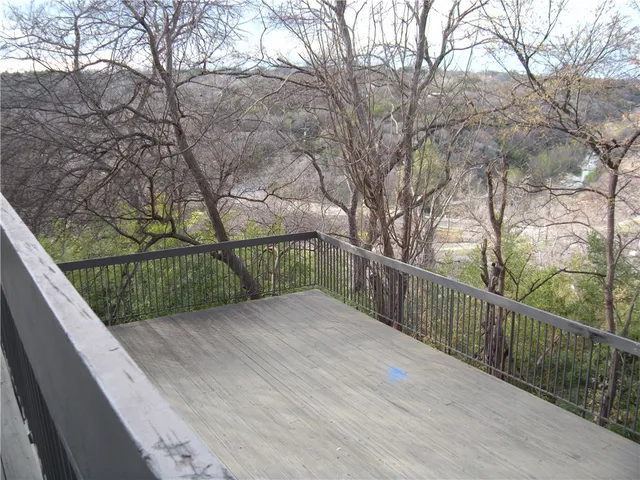 a view of mountain with wooden deck