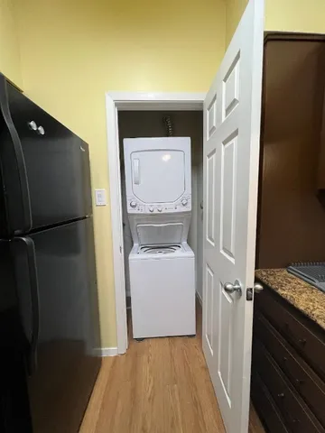 a room with a refrigerator and a stove