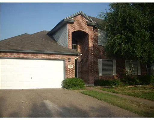 a view of a house with a yard and garage