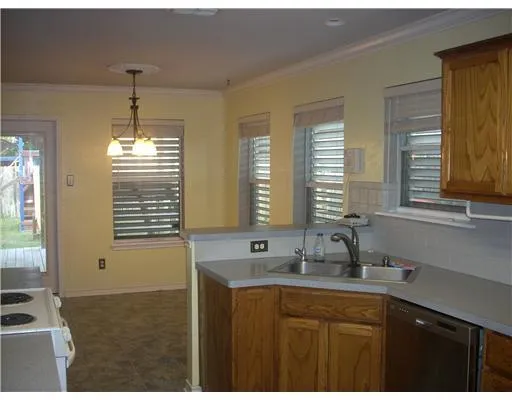 a kitchen with stainless steel appliances granite countertop a sink and a window