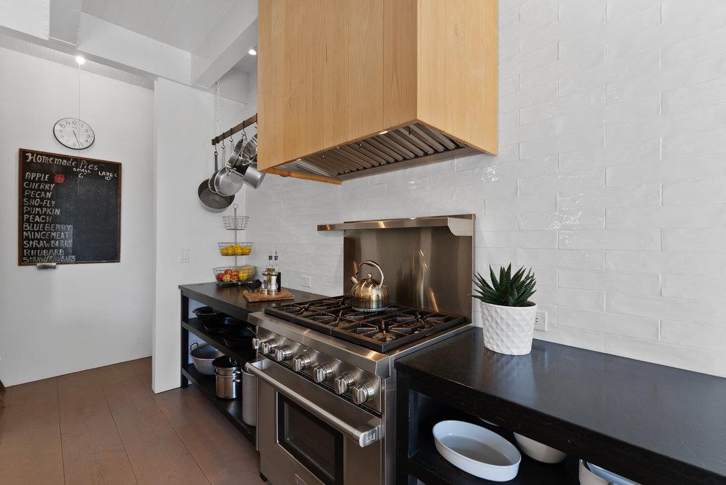 109 Central Avenue Capitola, CA 95010 - Photo 26 of 79 a kitchen with a stove and a wooden floor