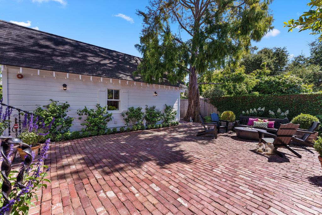 109 Central Avenue Capitola, CA 95010 - Photo 54 of 79 a backyard of a house with table and chairs