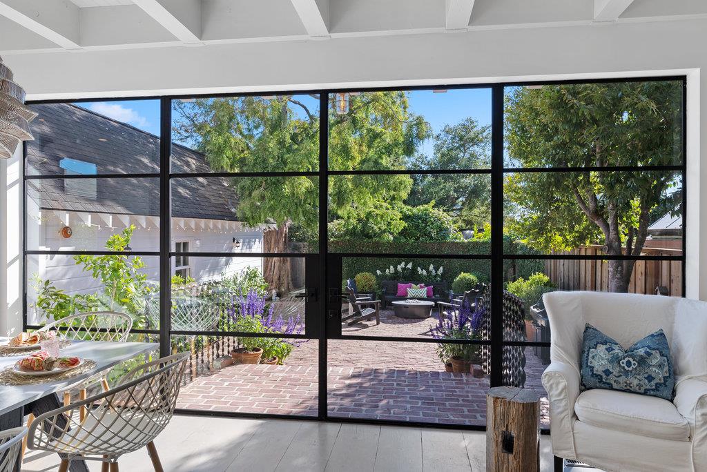 109 Central Avenue Capitola, CA 95010 - Photo 6 of 79 a living room with large windows and outdoor seating