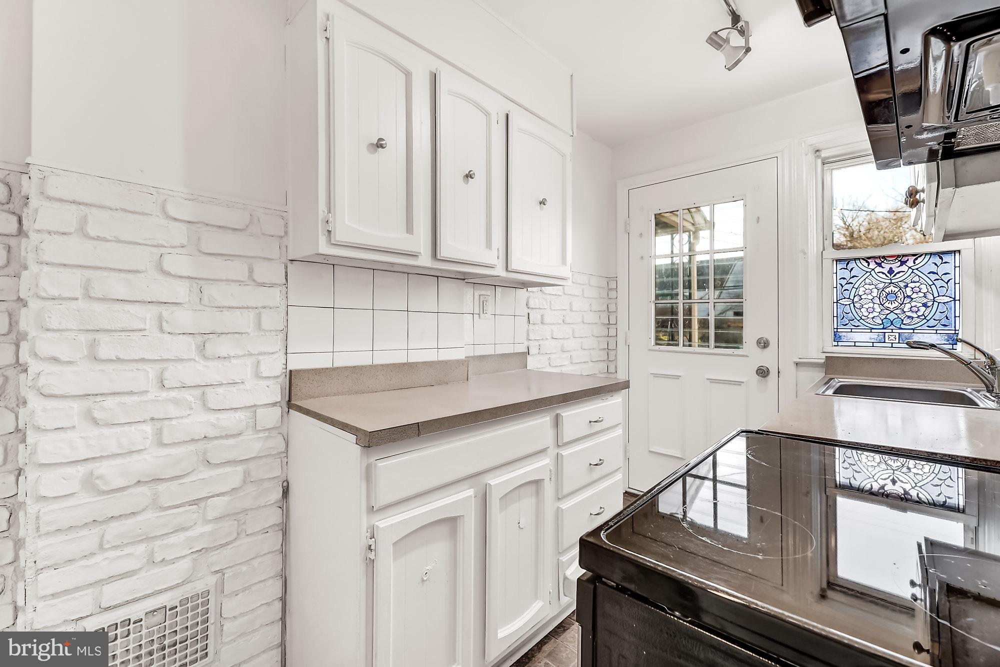 225 West Edgevale Road Baltimore, MD 21225 - Photo 9 of 25 exposed brick in kitchen.