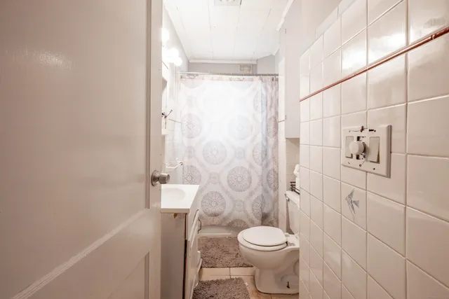 a bathroom with a toilet and shower