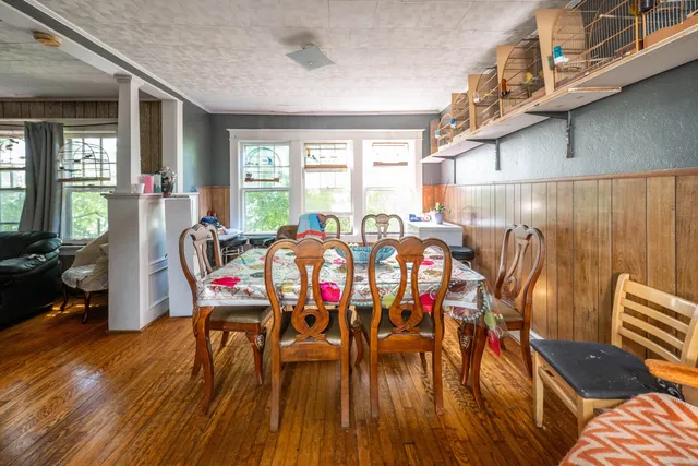 a view of a dining room with furniture window and wooden floor