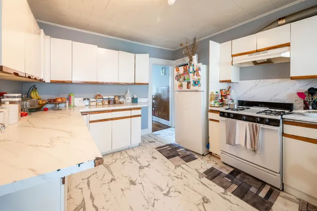 a kitchen with a refrigerator and a stove