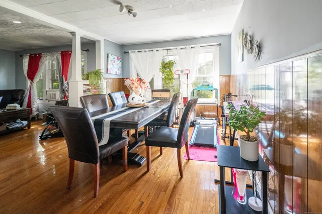 a view of a dining room with furniture window and wooden floor