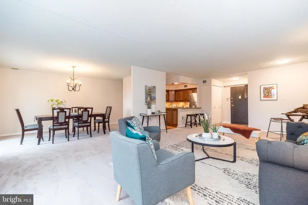 a kitchen with stainless steel appliances granite countertop a stove top oven a sink and a refrigerator
