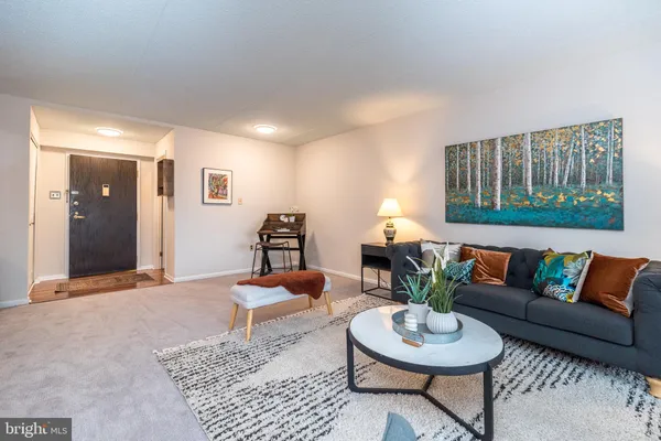 a living room with furniture and a lamp