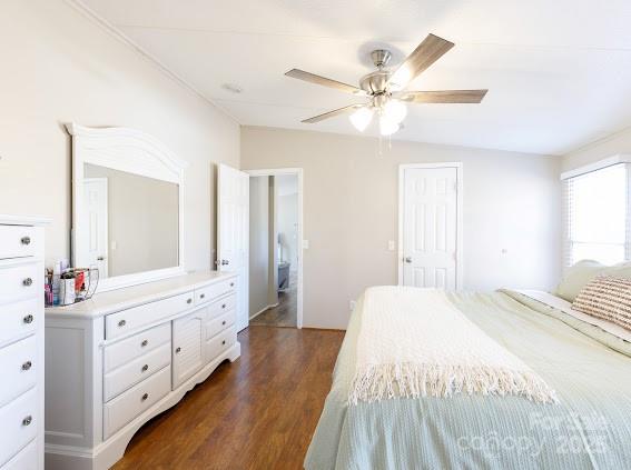 4195 Hurley Walters Road Lancaster, SC 29720 - Photo 12 of 16 a spacious bedroom with a large bed and a chandelier