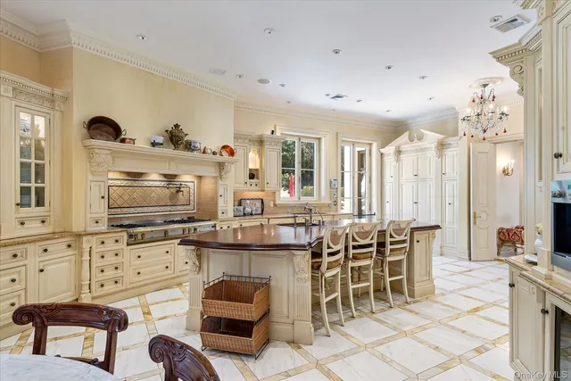 a kitchen with granite countertop a sink and chairs