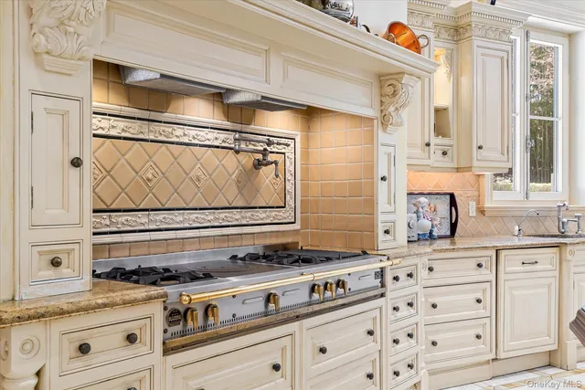 a stove top oven sitting inside of a kitchen