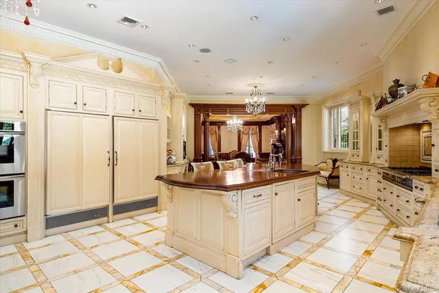 a kitchen with stainless steel appliances kitchen island granite countertop a sink and cabinets