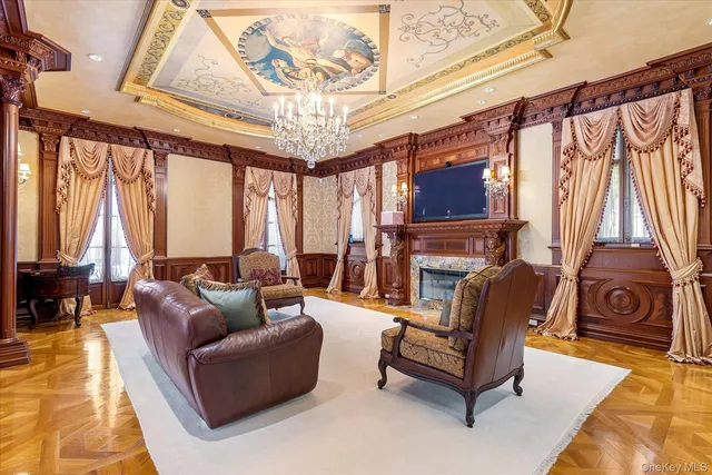 a living room with furniture and a chandelier