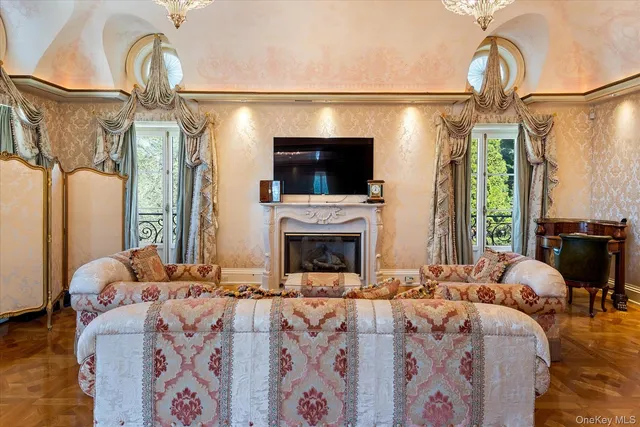 a living room with a fireplace furniture and a flat screen tv