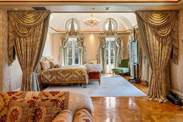 a bedroom with a bed and dresser with mirror