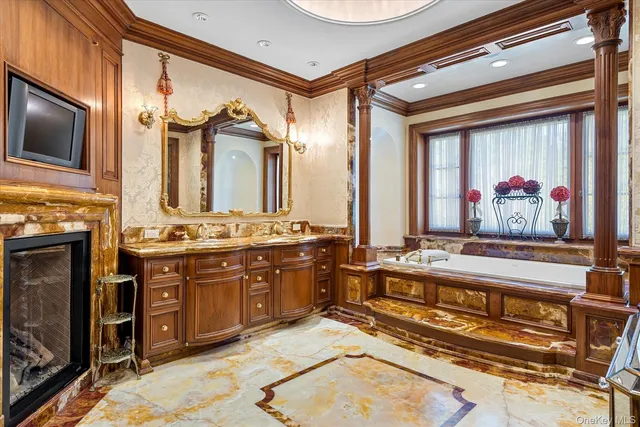 a spacious bathroom with a sink a large mirror and bathtub