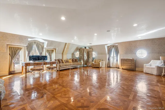 a view of a room with lots of furniture and wooden floor